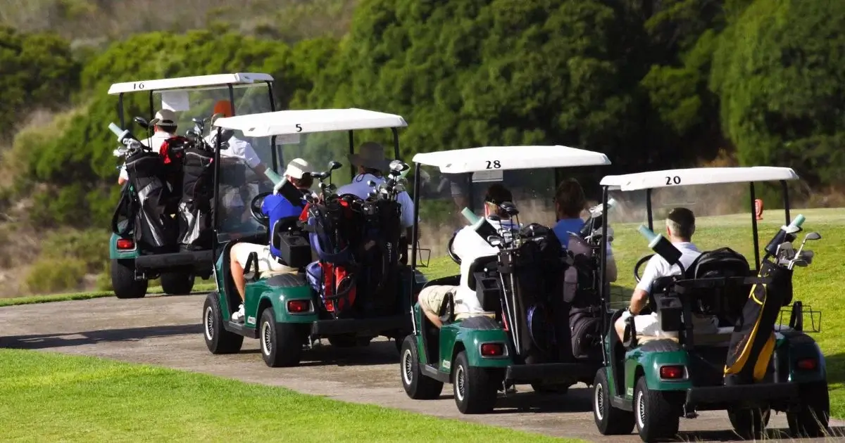 Golf carts carrying players to next hole